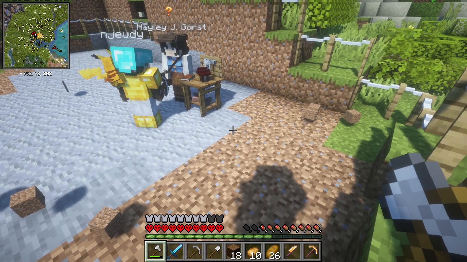 Capture de la série Les aventures de Zunk : deux joueurs devant la hutte du bâtisseur, l'interface du jeu visible